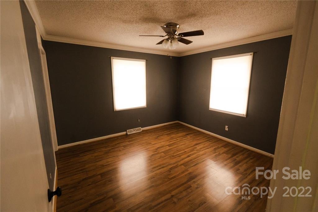 20450 Indian Mound Road Albemarle, NC 28001 - Photo 12 of 14 a view of empty room with wooden floor and fan