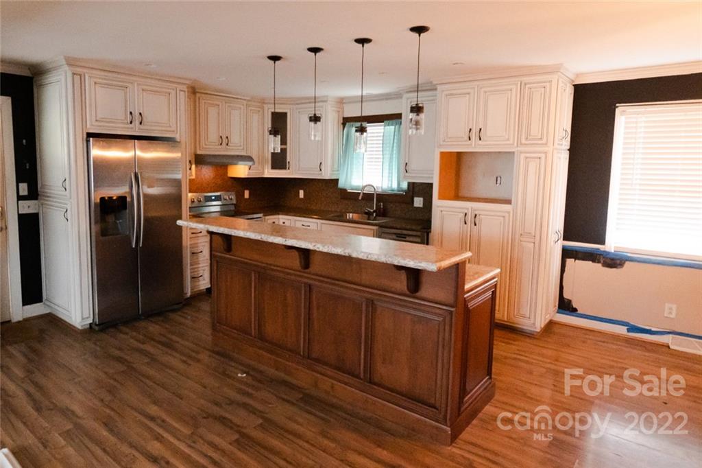 20450 Indian Mound Road Albemarle, NC 28001 - Photo 6 of 14 a kitchen with stainless steel appliances granite countertop a refrigerator a sink a stove and a refrigerator