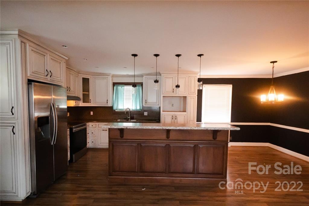 20450 Indian Mound Road Albemarle, NC 28001 - Photo 7 of 14 a kitchen with stainless steel appliances granite countertop a sink stove and refrigerator