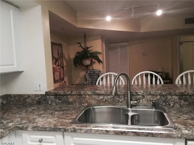 a kitchen with a stove a sink and a table with chairs