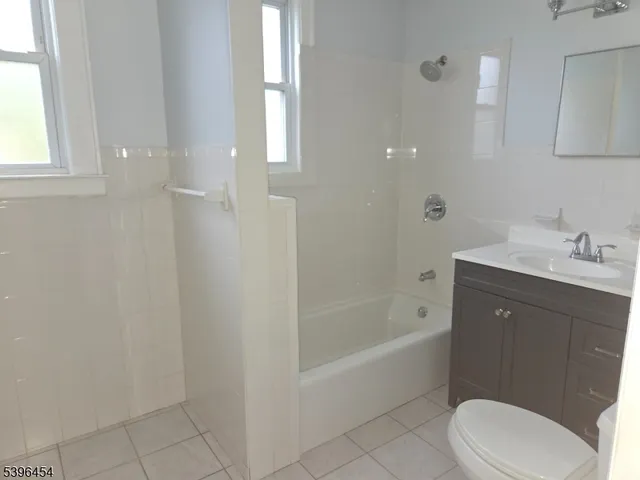 a view of a hallway to rooms and stairs