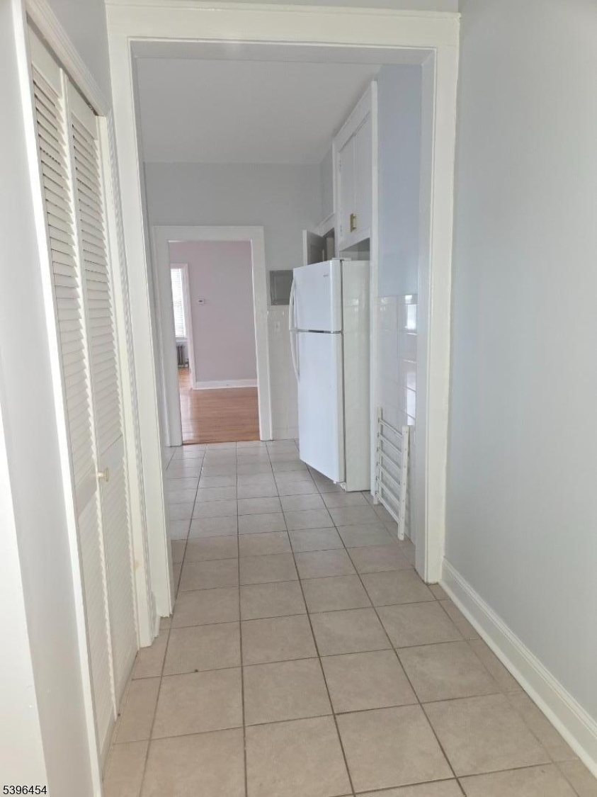 292 Leslie Street, Unit 1R Newark, NJ 07112 - Photo 9 of 9 a view of a hallway to rooms and stairs