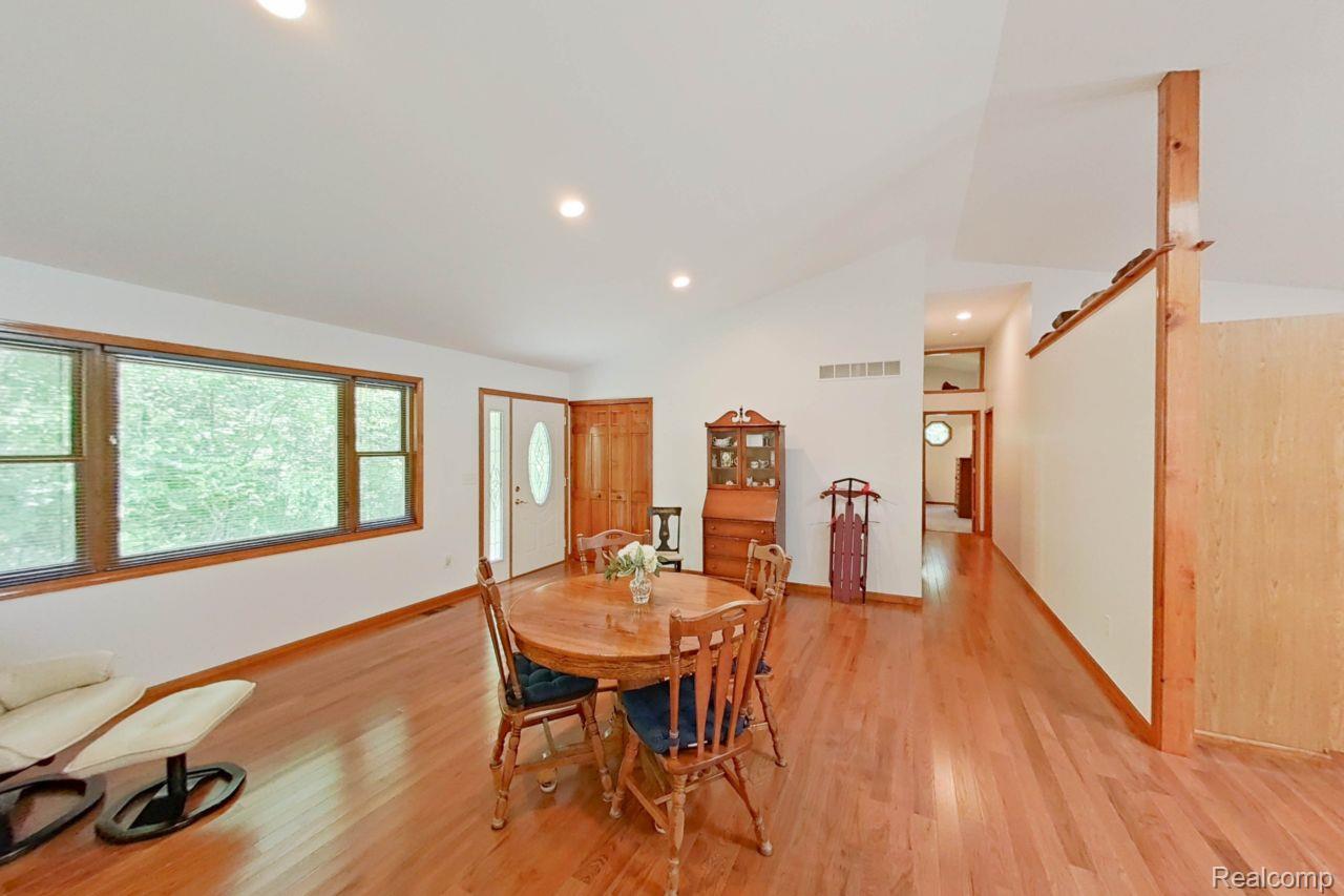10201 Washburn Road Goodrich, MI 48438 - Photo 26 of 85 Open-concept living space featuring wood-finish flooring, recessed lighting, and vaulted ceilings