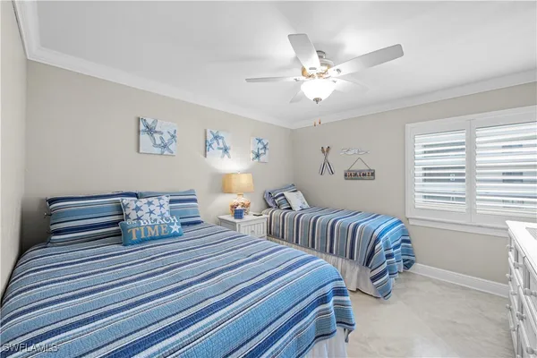 a bedroom with two beds and a chandelier