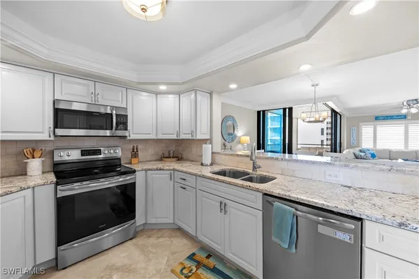 a kitchen with a sink stove and microwave