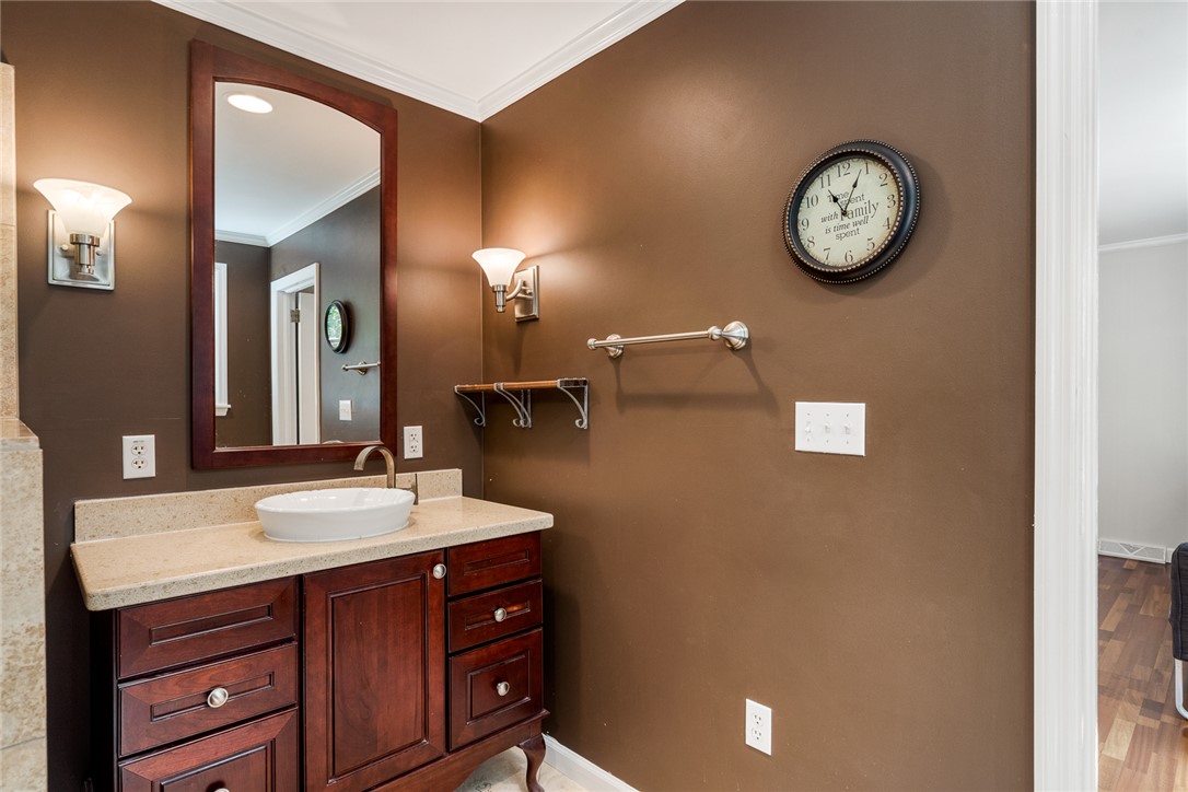 512 East Fredericks Street Anderson, SC 29621 - Photo 15 of 31 A vessel sink vanity with ample storage and a broad mirror anchors this functional bathroom space.