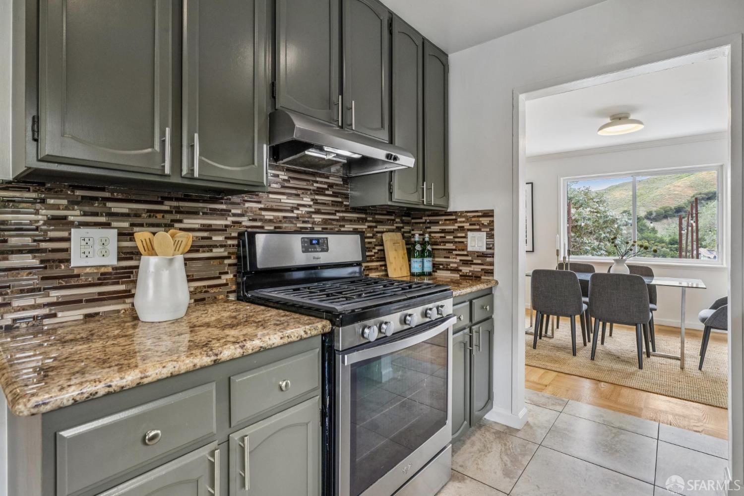 545 Talbot Avenue Pacifica, CA 94044 - Photo 33 of 87 a kitchen with granite countertop a stove top oven microwave and cabinets