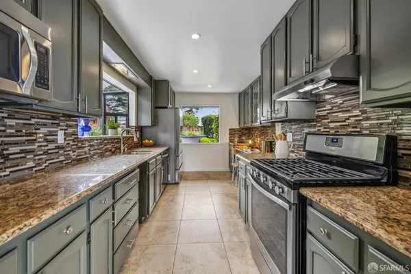 a spacious bathroom with a granite countertop sink and a mirror