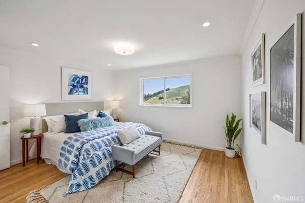 a room with painting on the wall and a potted plant
