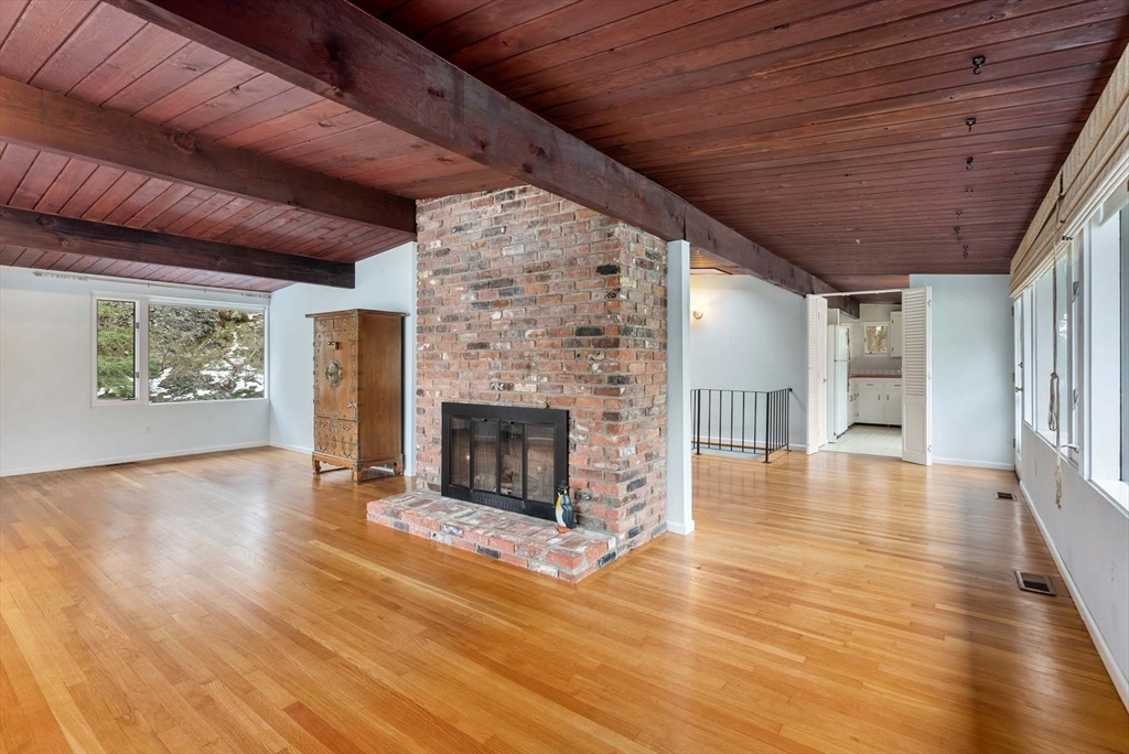 34 Bellingham Road Brookline, MA 02467 - Photo 16 of 33 a view of an empty room with wooden floor fireplace and a window