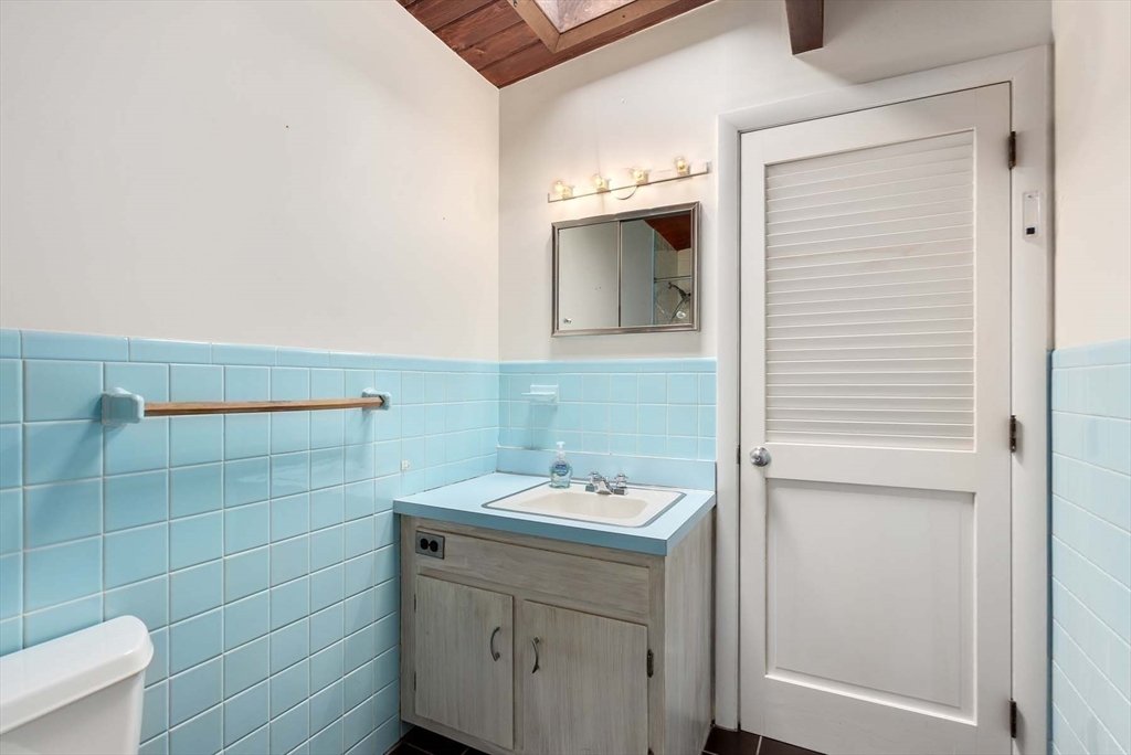 34 Bellingham Road Brookline, MA 02467 - Photo 27 of 33 a bathroom with a sink and mirror