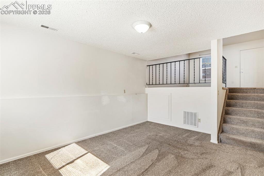 6745 Parkridge Court Colorado Springs, CO 80915 - Photo 13 of 23 a view of a hallway with staircase