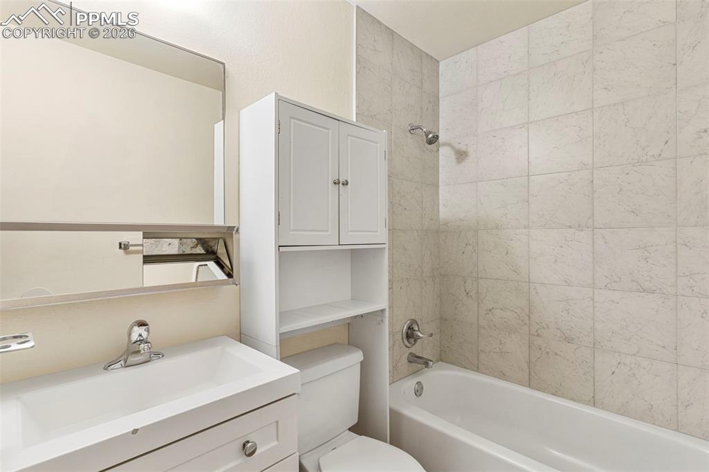 6745 Parkridge Court Colorado Springs, CO 80915 - Photo 17 of 23 a bathroom with a sink toilet a bathtub and vanity