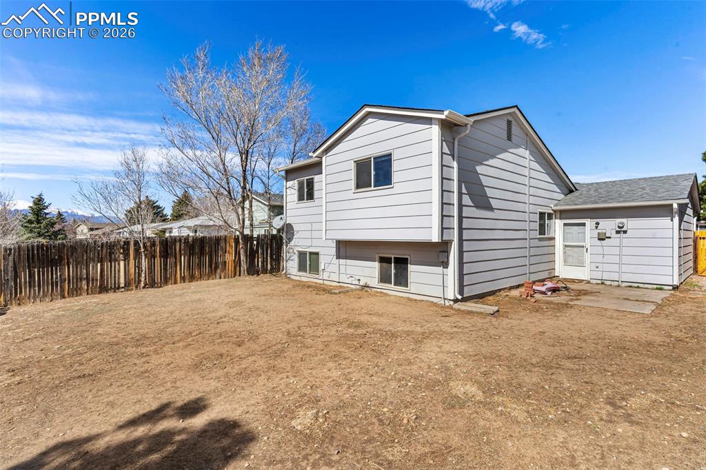 6745 Parkridge Court Colorado Springs, CO 80915 - Photo 22 of 23 a view of house with backyard and trees in the background