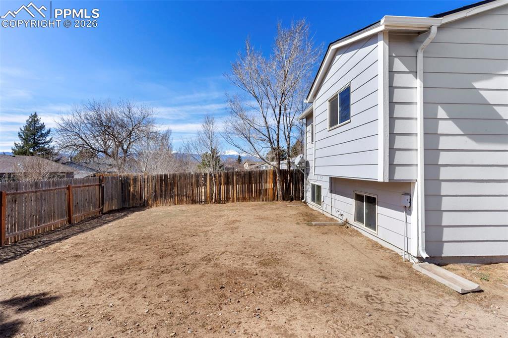 6745 Parkridge Court Colorado Springs, CO 80915 - Photo 23 of 23 a view of backyard with wooden fence
