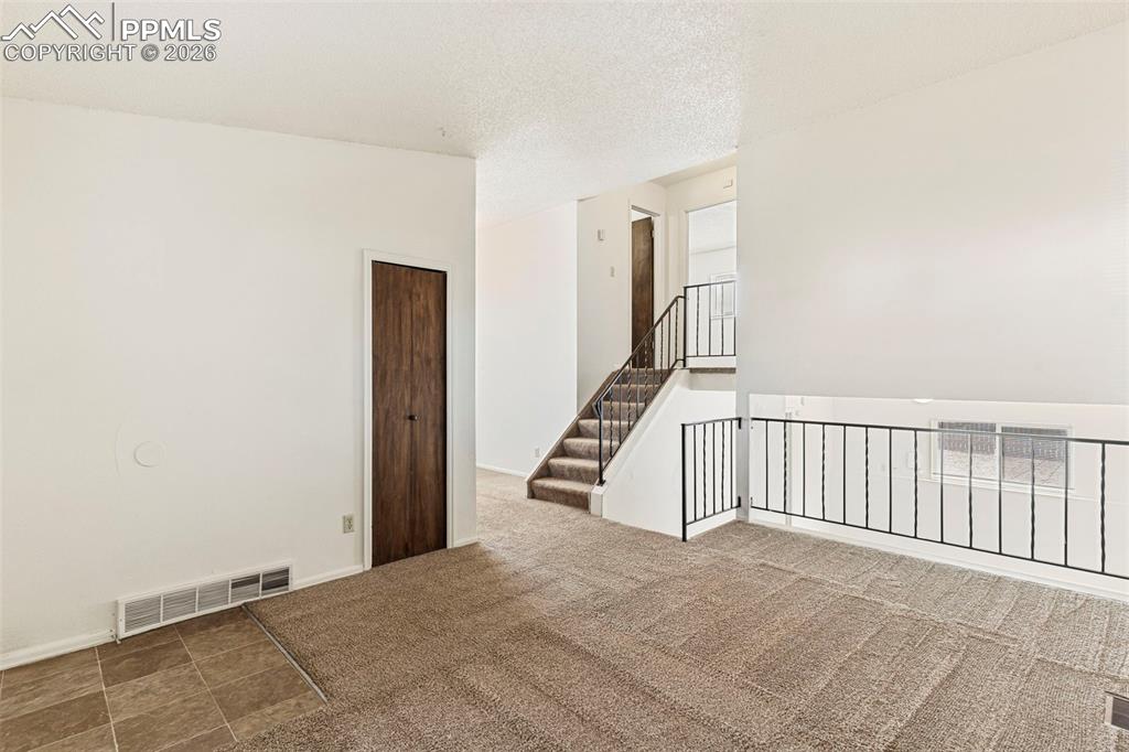6745 Parkridge Court Colorado Springs, CO 80915 - Photo 4 of 23 a view of a hallway with staircase