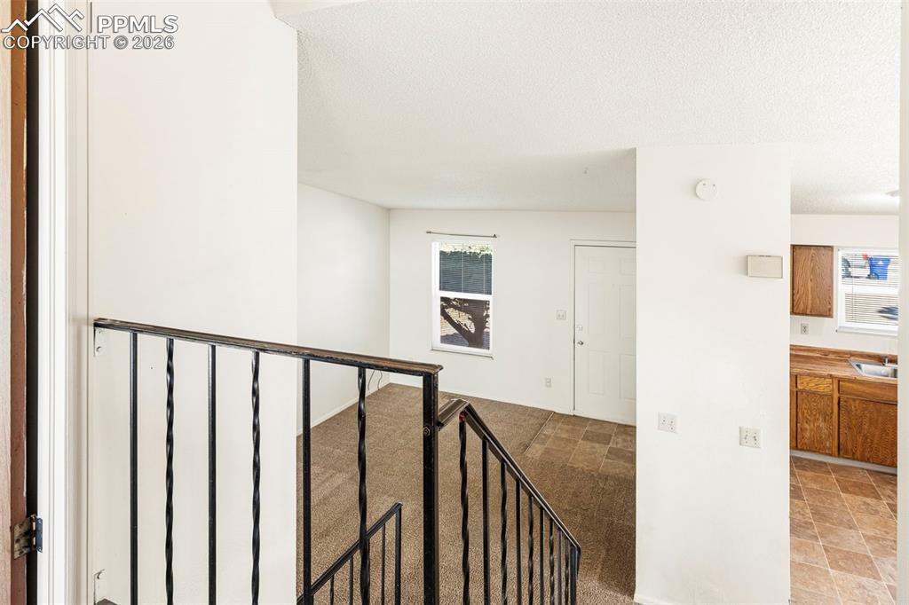 6745 Parkridge Court Colorado Springs, CO 80915 - Photo 5 of 23 a view of a hallway with wooden floor and entryway