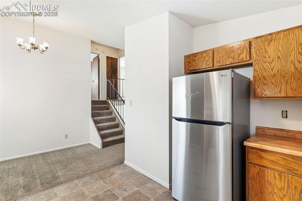 6745 Parkridge Court Colorado Springs, CO 80915 - Photo 9 of 23 a white refrigerator freezer and a stove sitting inside of a kitchen