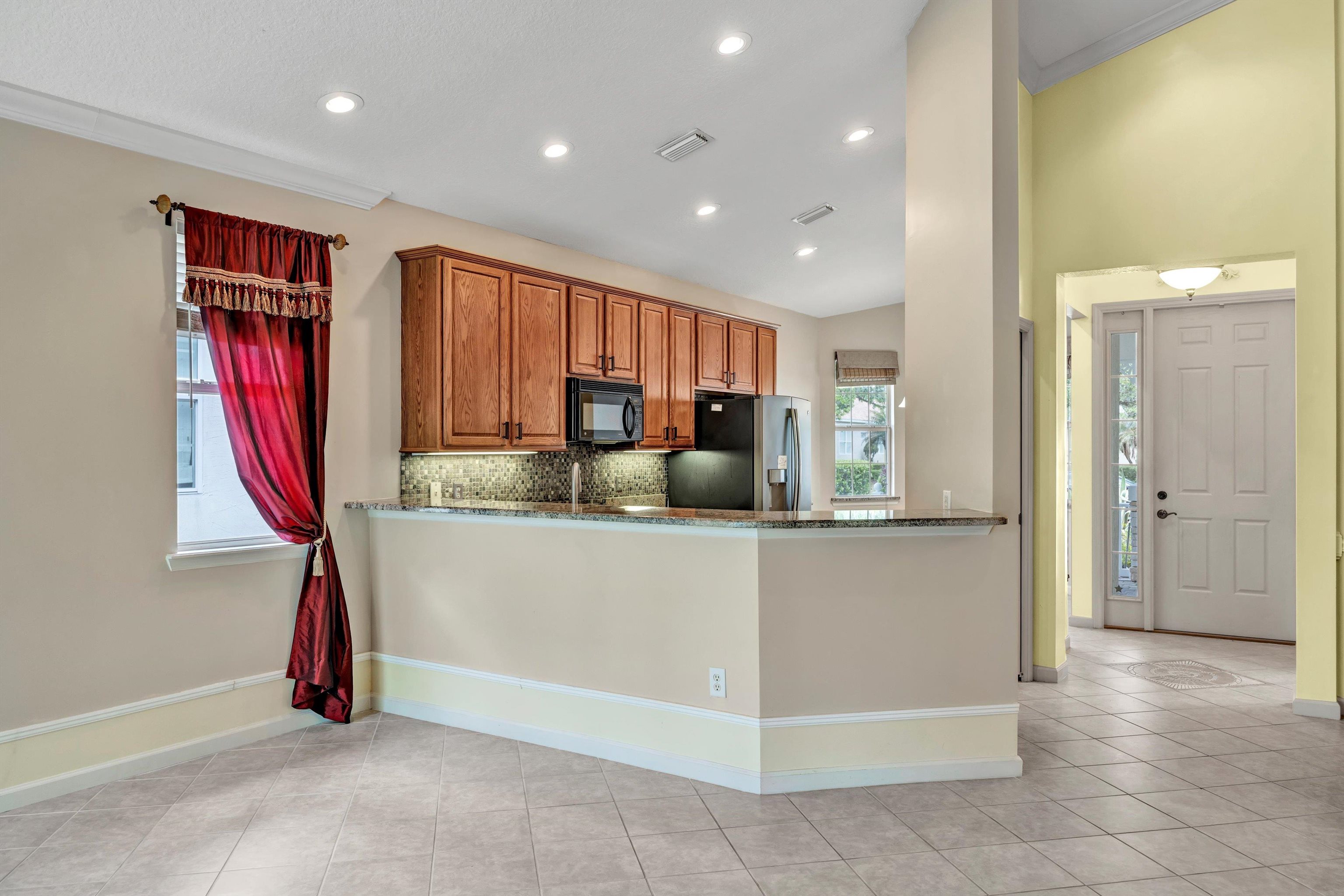 608 Copperhead Circle St. Augustine, FL 32092 - Photo 15 of 65 a kitchen with stainless steel appliances granite countertop a refrigerator and a sink