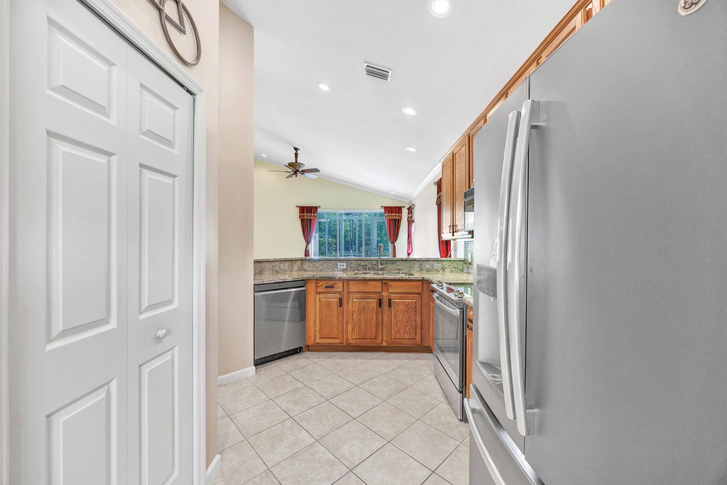 608 Copperhead Circle St. Augustine, FL 32092 - Photo 18 of 65 Another picture taken from the first entrance to the kitchen, with the dinette behind the photographer and the pantry to the left, with the large stainless refrigerator in the foreground.