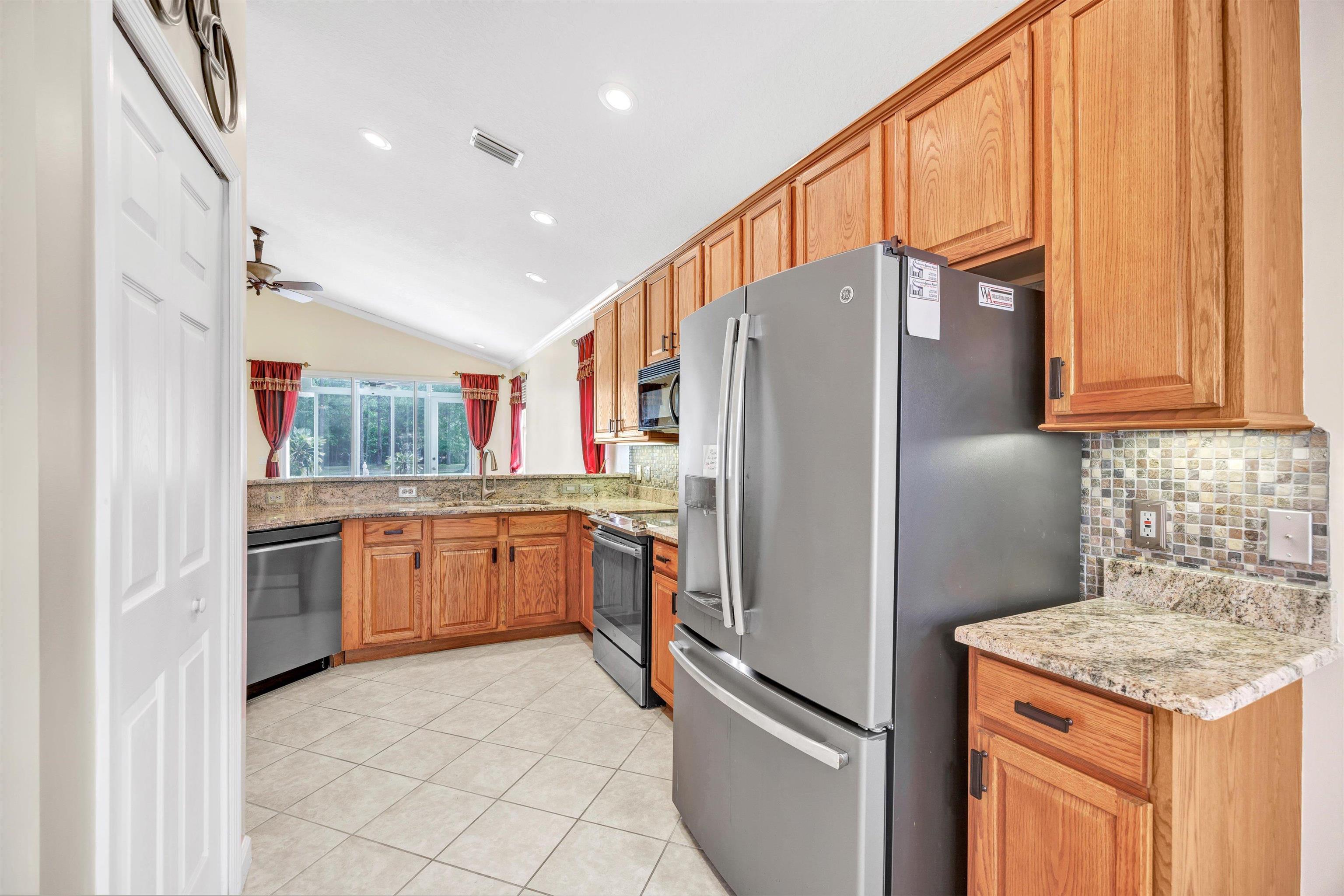 608 Copperhead Circle St. Augustine, FL 32092 - Photo 19 of 65 Facing north, with the dinette and first entry into the kitchen behind the photographer, there is a full pantry to the left and a full kitchen easy to maneuver around.