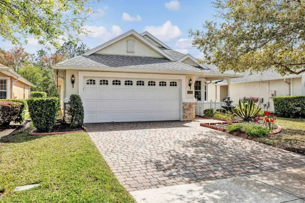 a living room with furniture kitchen view and a chandelier