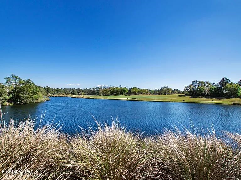 608 Copperhead Circle St. Augustine, FL 32092 - Photo 50 of 65 a view of a lake with houses in the back