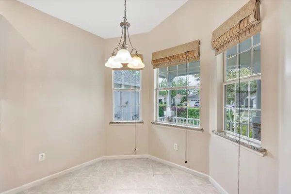 a view of a living room with furniture and a chandelier