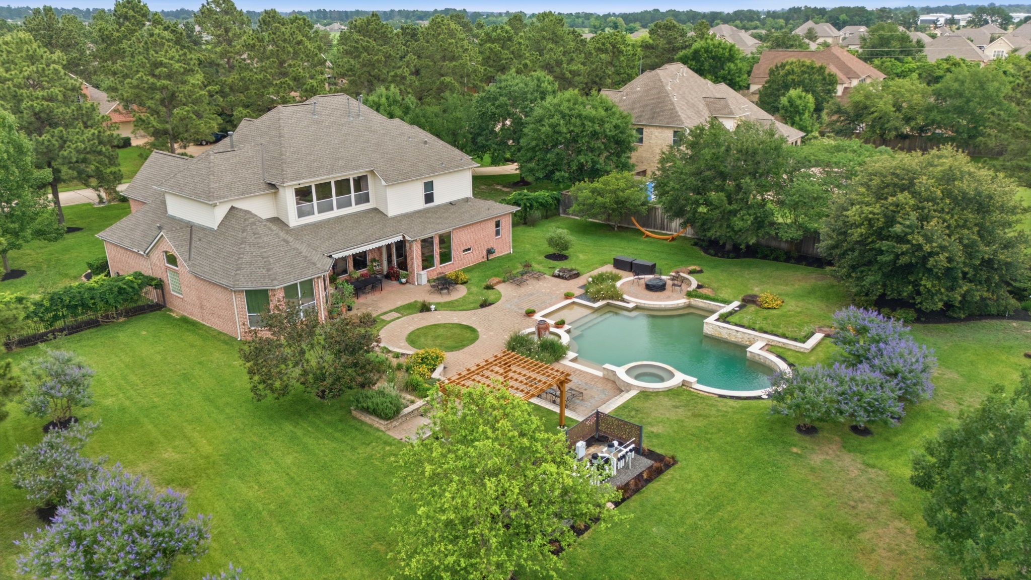15 White Meadow Court Spring, TX 77379 - Photo 13 of 43 Beautiful Vitek trees are in bloom and offer stunning color. and privacy. Recently added pergola with power. Great spot for an outdoor kitchen with the natural gas line in place from the pool equipmenr.