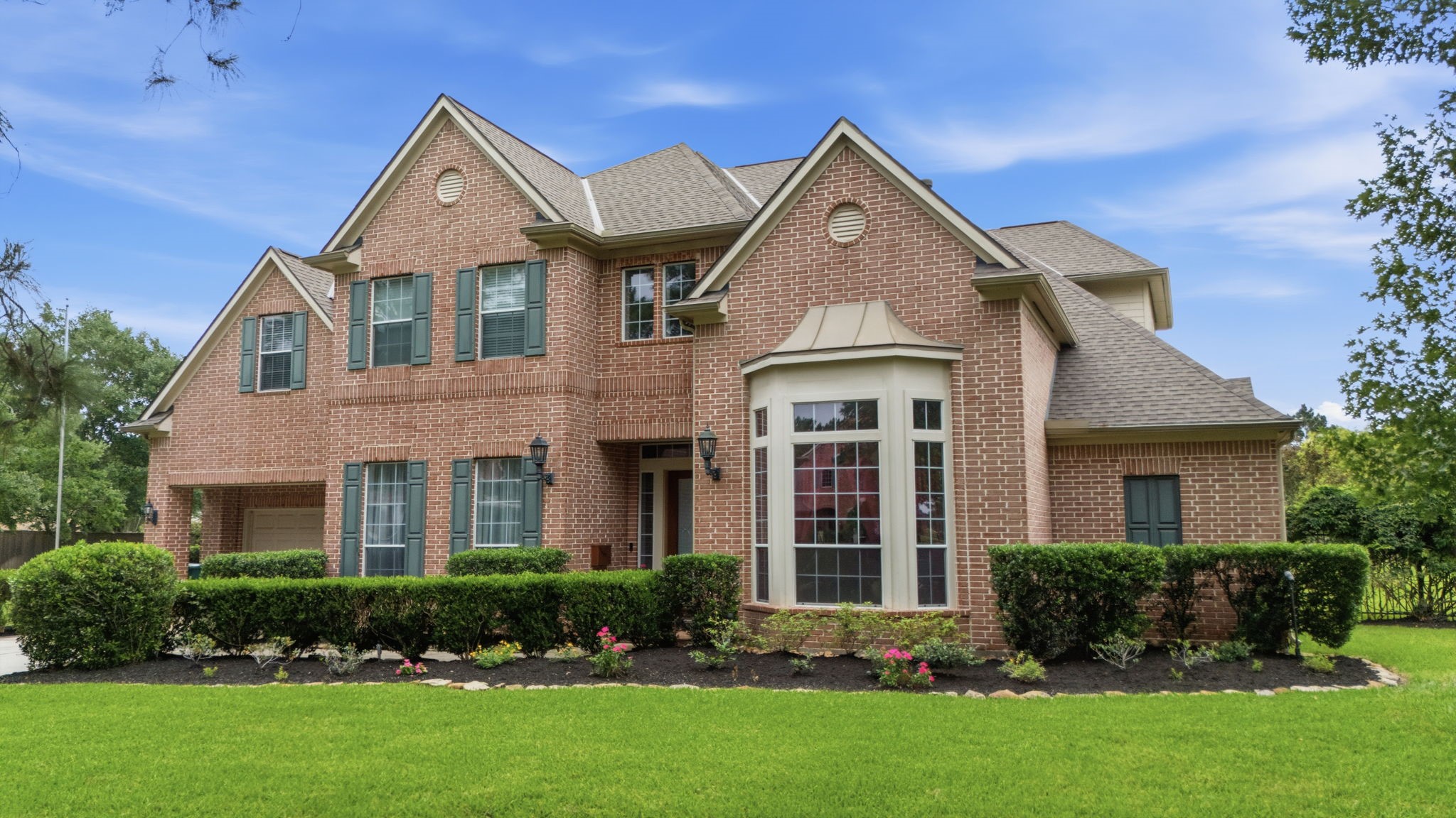 15 White Meadow Court Spring, TX 77379 - Photo 2 of 43 Stately red brick exterior with green shutters