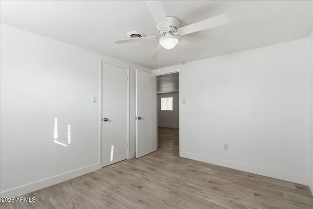 a view of an empty room with wooden floor