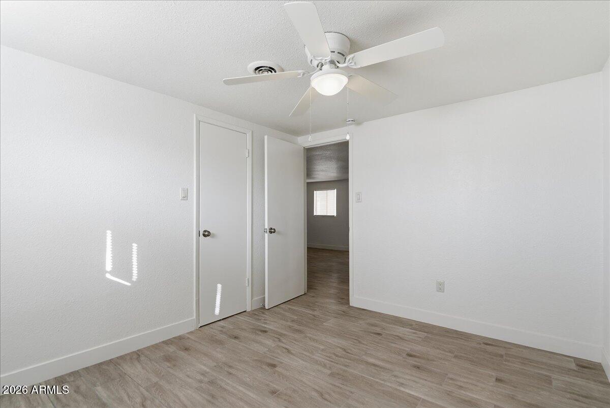 451 East 10th Avenue Apache Junction, AZ 85119 - Photo 11 of 21 a view of an empty room with wooden floor