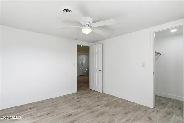 a view of an empty room with a fan