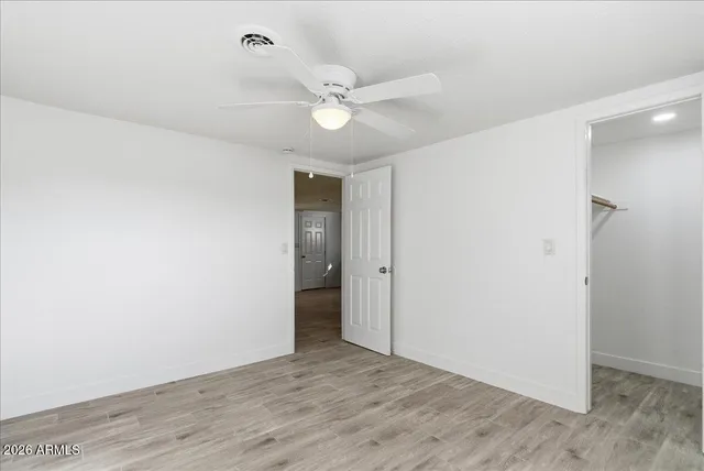 a view of an empty room with a fan
