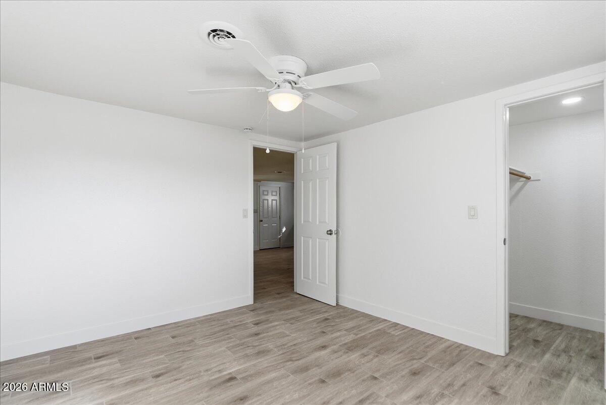 451 East 10th Avenue Apache Junction, AZ 85119 - Photo 13 of 21 a view of an empty room with a fan