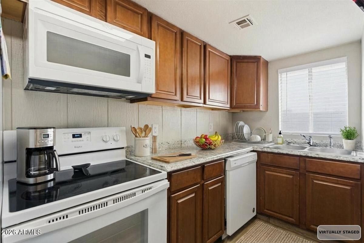 451 East 10th Avenue Apache Junction, AZ 85119 - Photo 17 of 21 a kitchen with a sink and cabinets