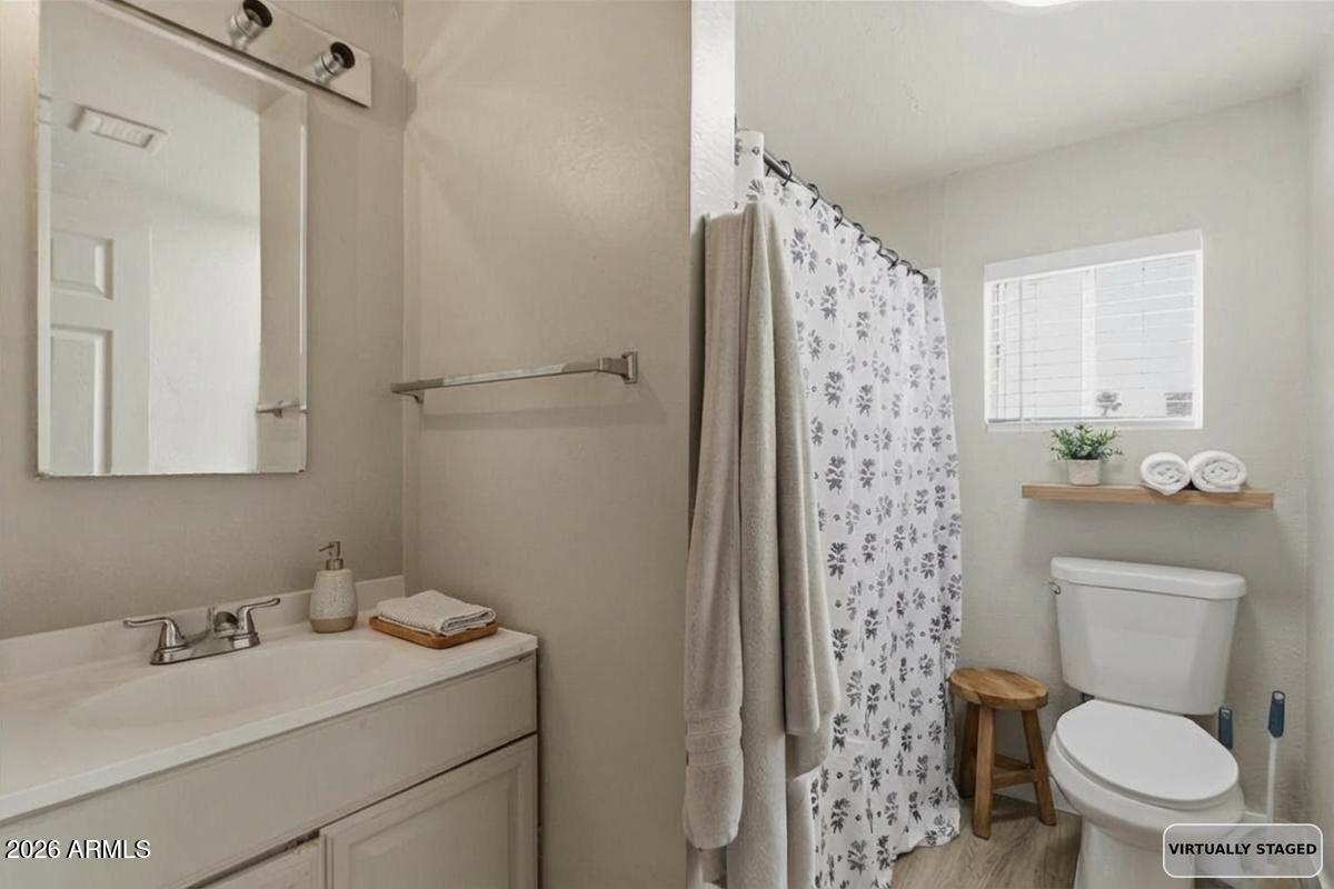 451 East 10th Avenue Apache Junction, AZ 85119 - Photo 18 of 21 a bathroom with a granite countertop toilet sink and shower