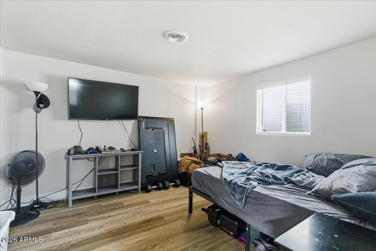 451 East 10th Avenue Apache Junction, AZ 85119 - Photo 20 of 21 a living room with furniture and a flat screen tv