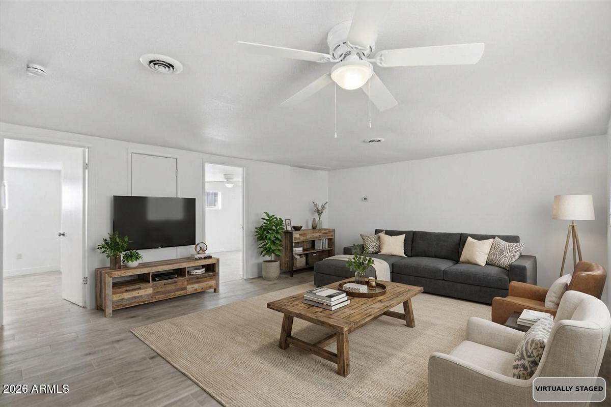 451 East 10th Avenue Apache Junction, AZ 85119 - Photo 6 of 21 a living room with furniture and a flat screen tv