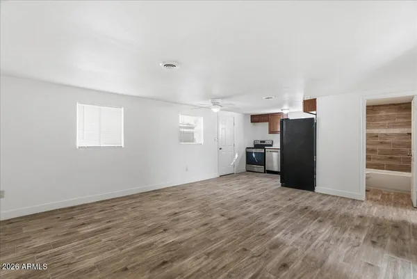 a view of a kitchen with refrigerator and window