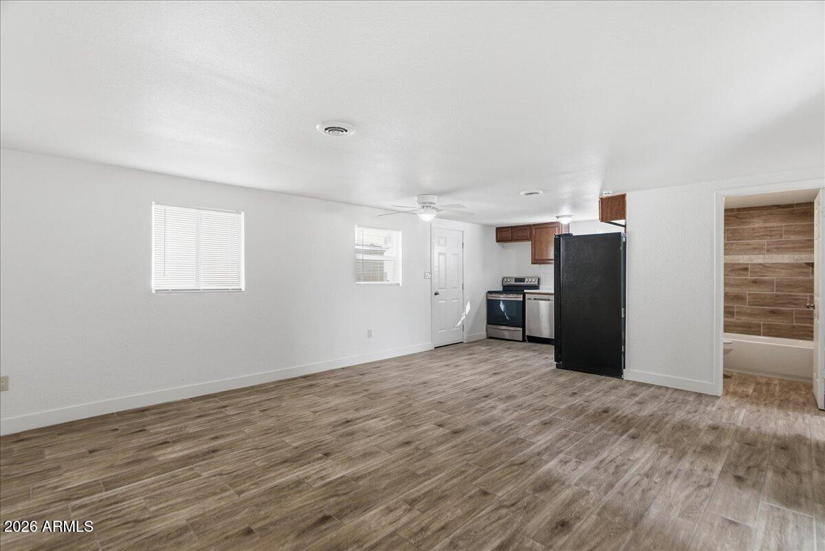 451 East 10th Avenue Apache Junction, AZ 85119 - Photo 7 of 21 a view of a kitchen with refrigerator and window