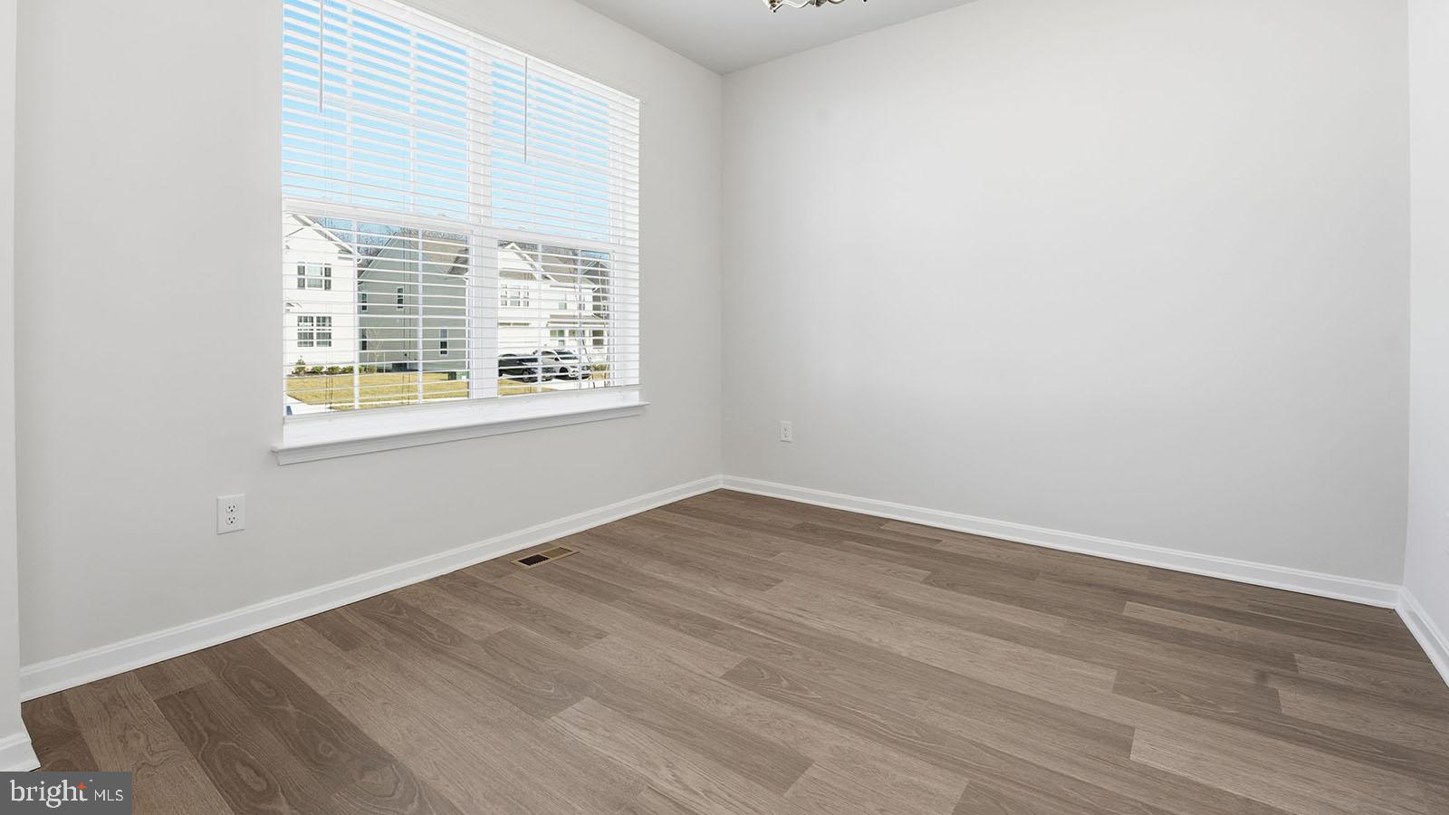 8110 Cypress Pt Drive Rosedale, MD 21237 - Photo 9 of 37 an empty room with wooden floor and windows