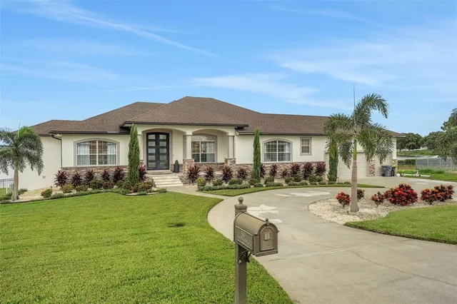 a front view of a house with a garden and patio