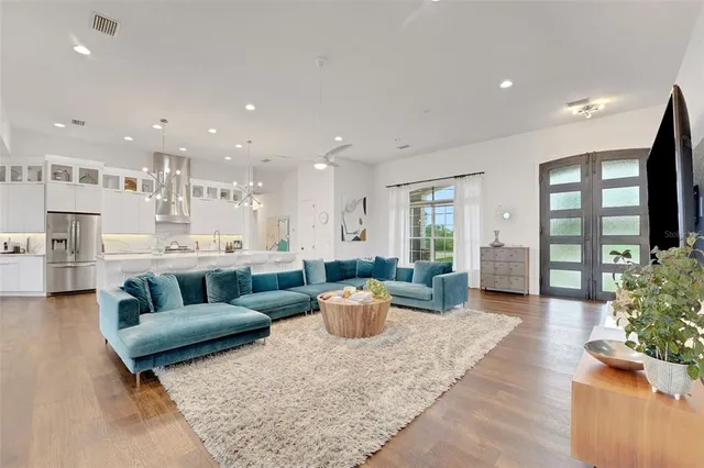 a large kitchen with stainless steel appliances lots of counter space and wooden floor