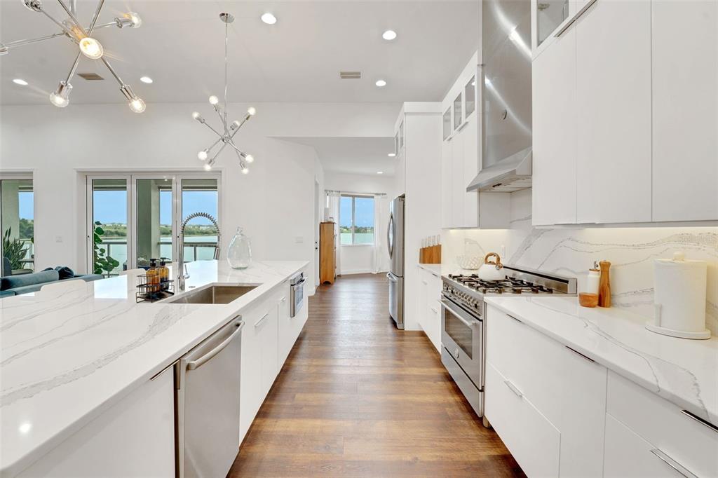 5911 Old Berkley Road Auburndale, FL 33823 - Photo 18 of 91 a large kitchen with stainless steel appliances lots of counter space and wooden floor