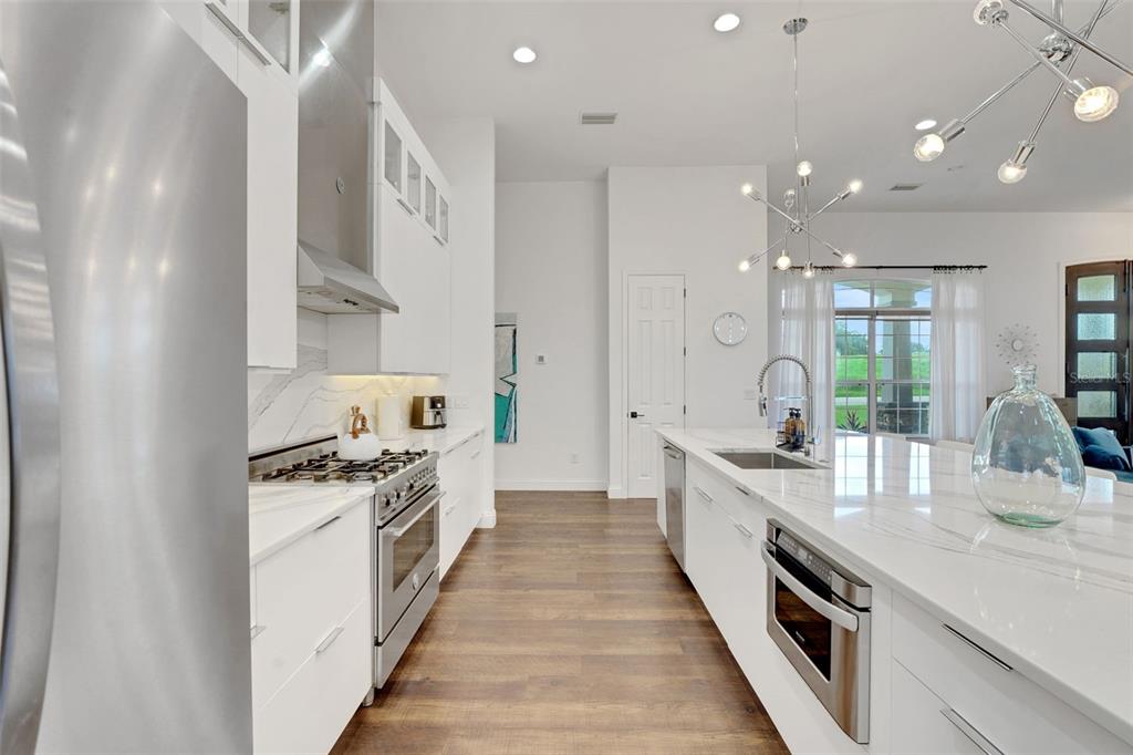5911 Old Berkley Road Auburndale, FL 33823 - Photo 19 of 91 a large white kitchen with stainless steel appliances