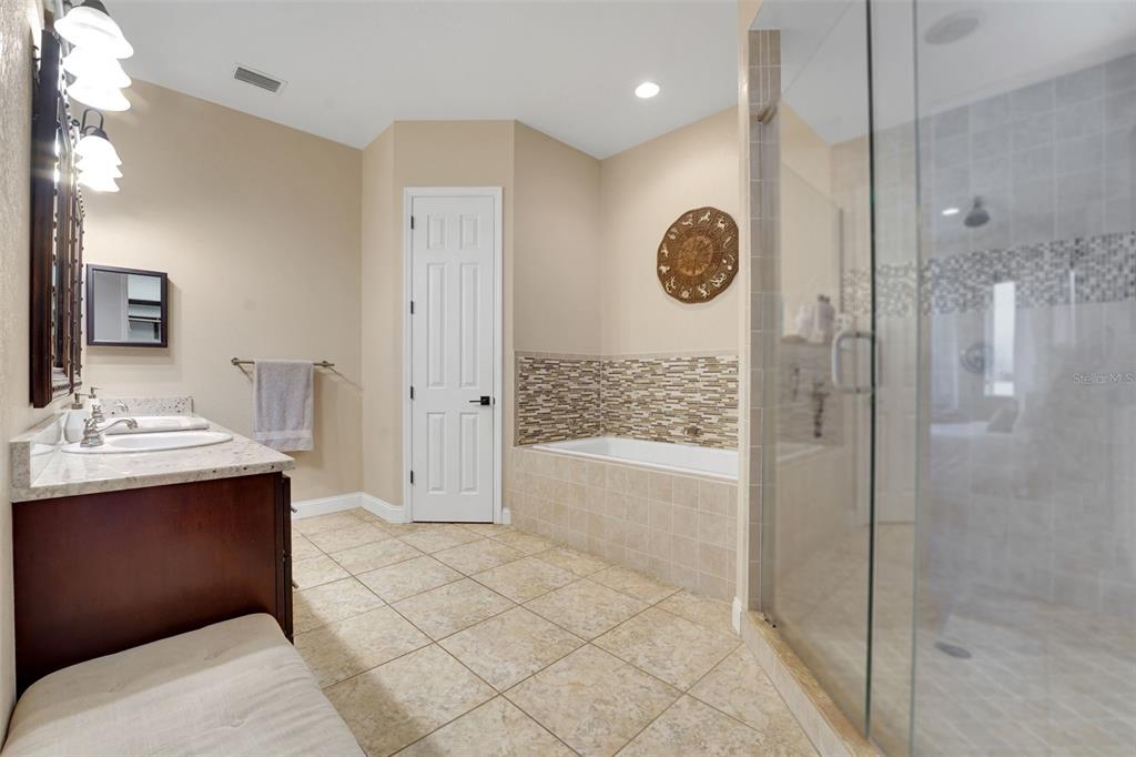 5911 Old Berkley Road Auburndale, FL 33823 - Photo 34 of 91 a bathroom with a bathtub a shower a sink and mirror