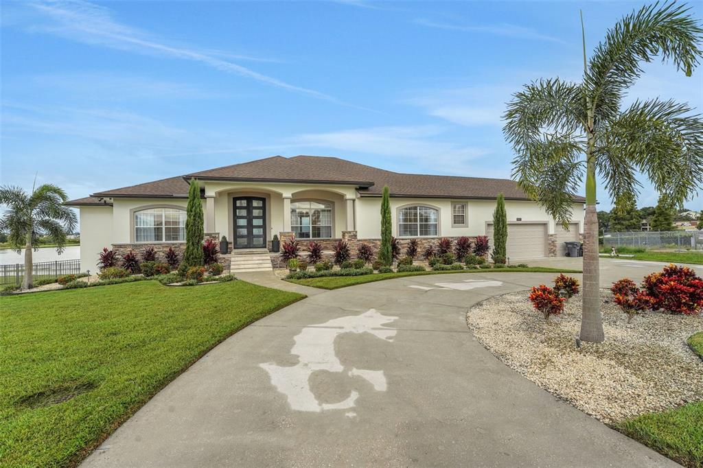 5911 Old Berkley Road Auburndale, FL 33823 - Photo 4 of 91 a front view of a house with garden