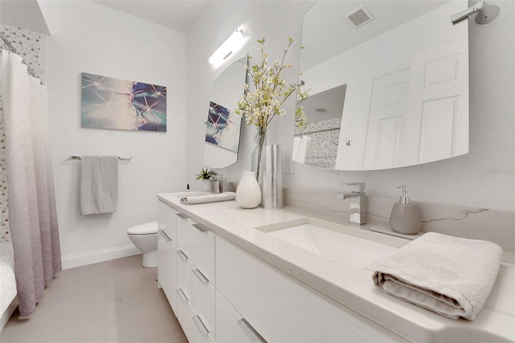 5911 Old Berkley Road Auburndale, FL 33823 - Photo 41 of 91 a bathroom with a double vanity sink mirror and