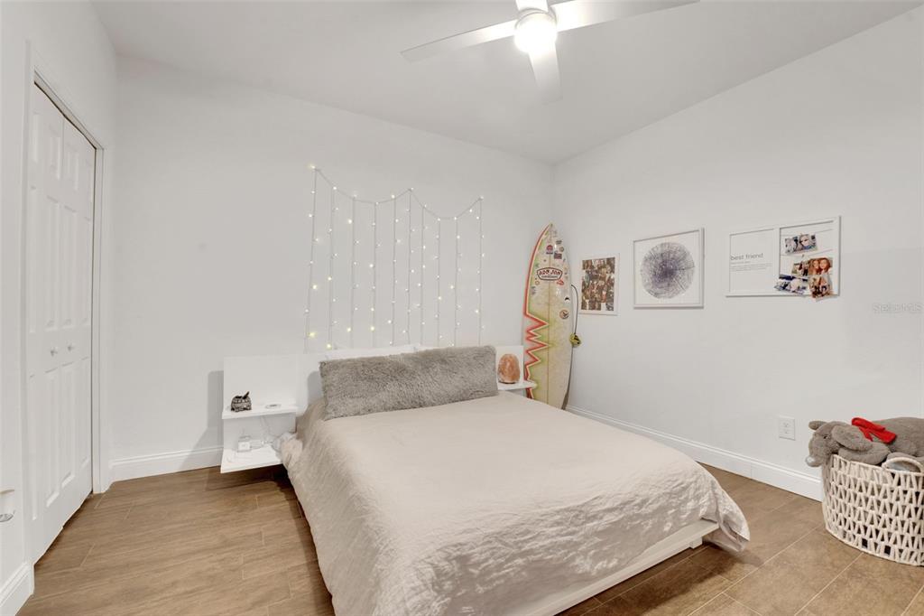 5911 Old Berkley Road Auburndale, FL 33823 - Photo 50 of 91 a bedroom with a bed and a chandelier